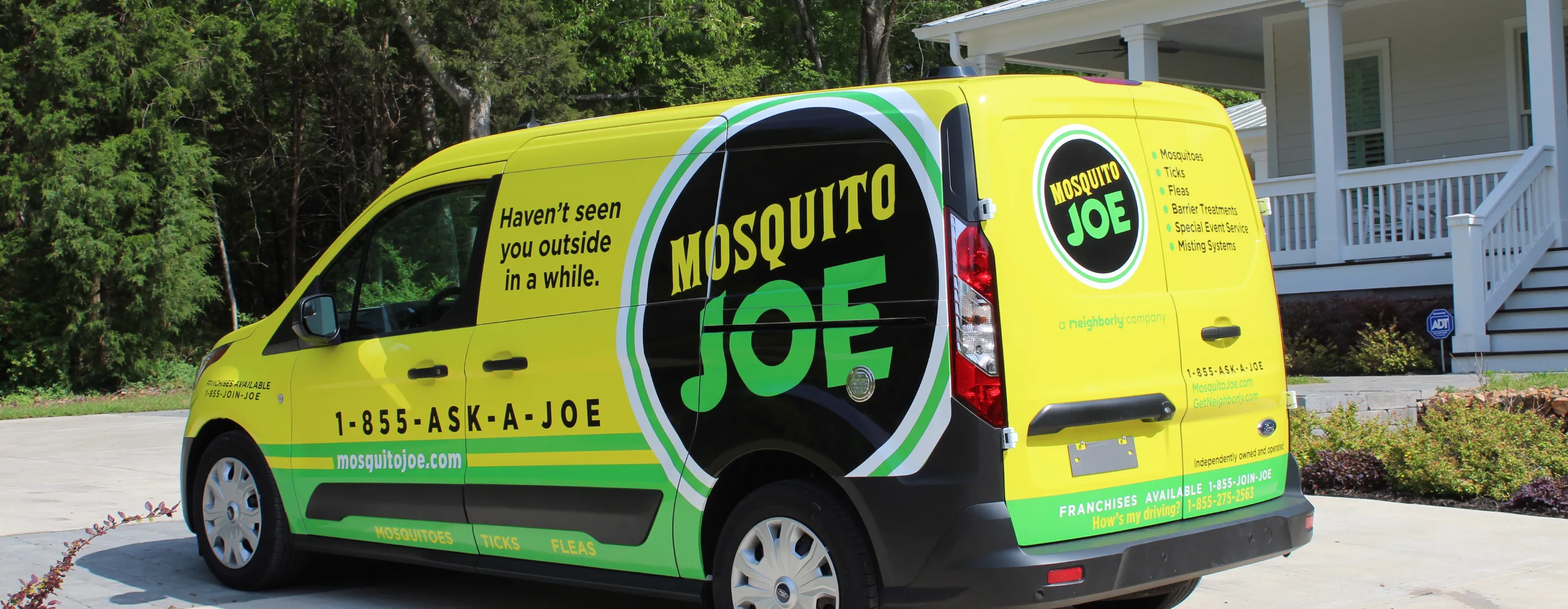 Mosquito Joe branded van parked in front of home.