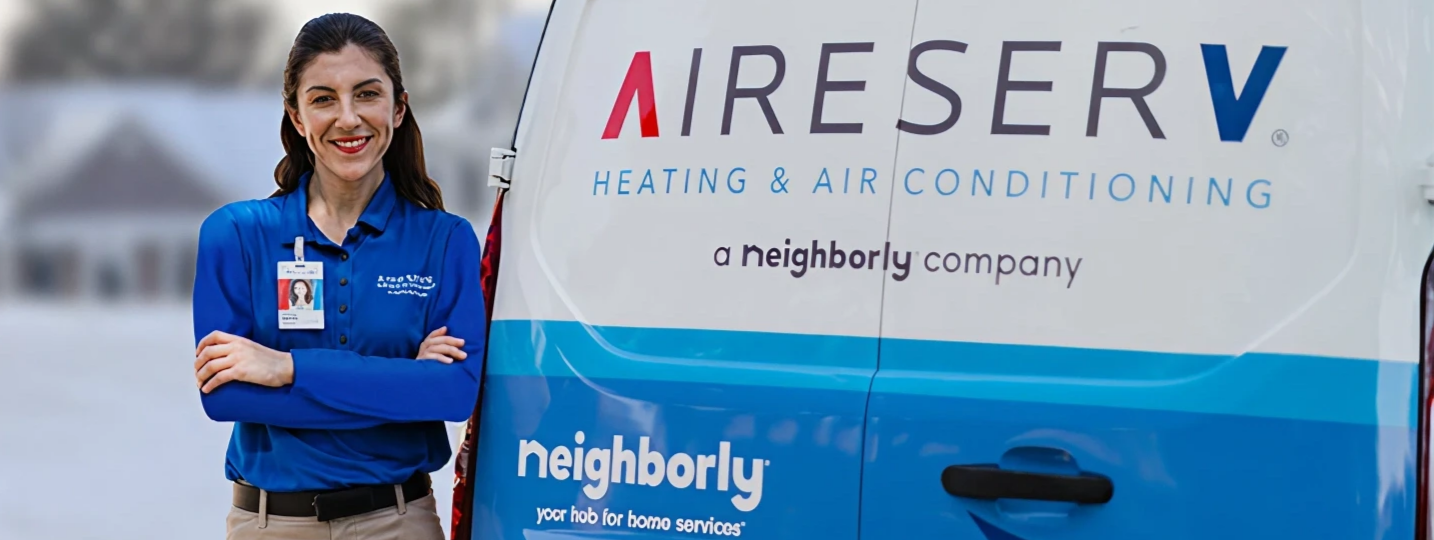 Woman standing near Aire Serv van.