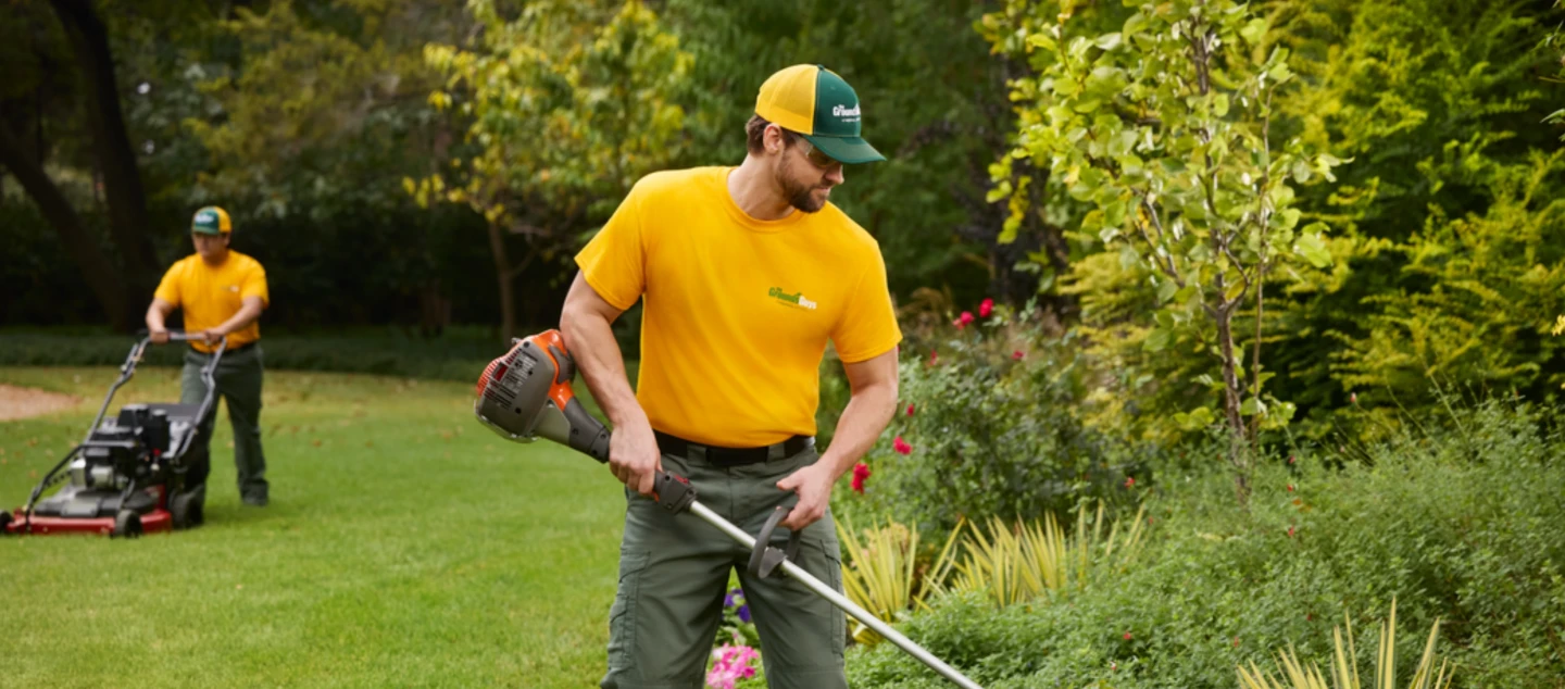 Technician trimming bushes.