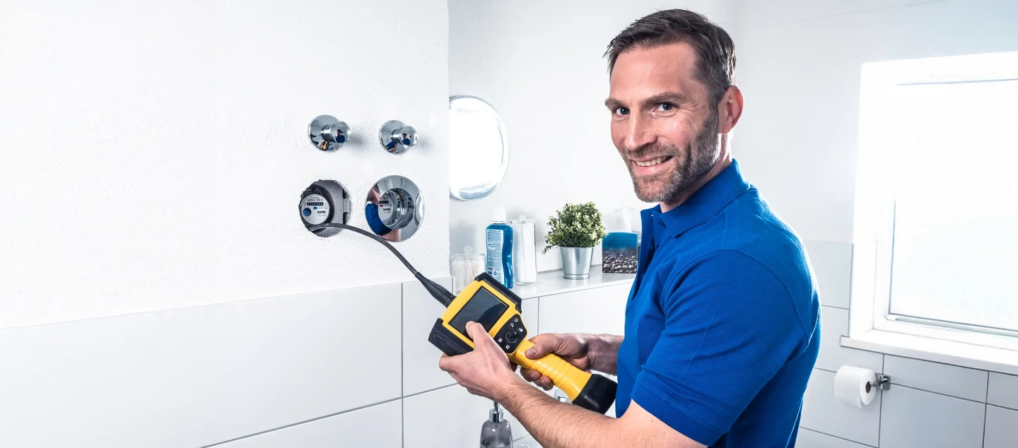 Technician holding tool.