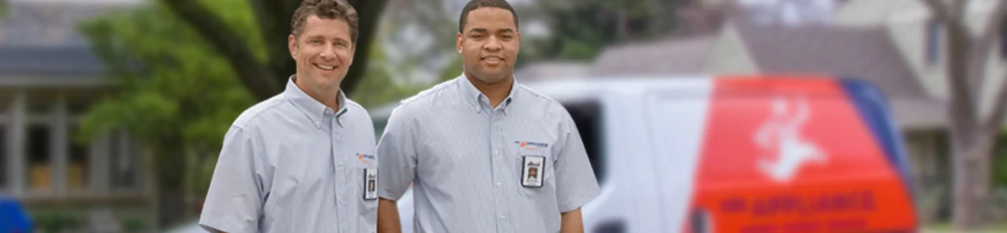Service professional standing in front of Mr. Appliance van.