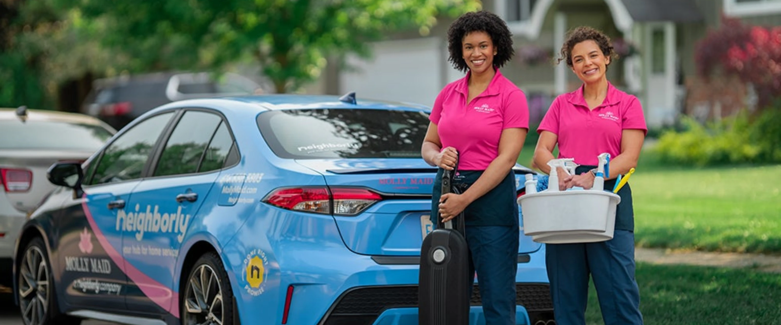 Branded Molly Maid car parked in front of home.