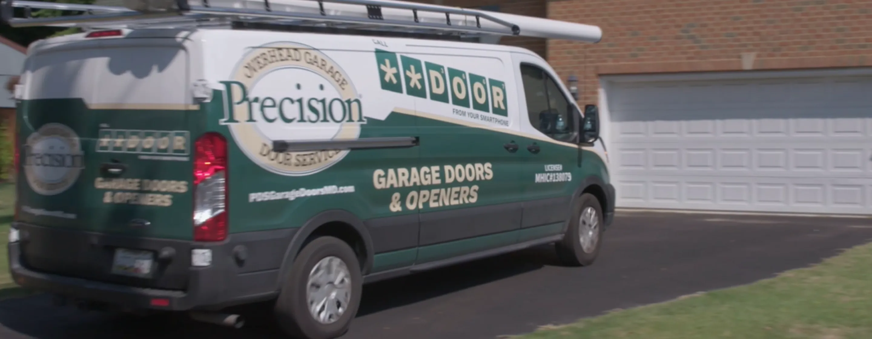 Precision Door Branded truck parked in front of home.