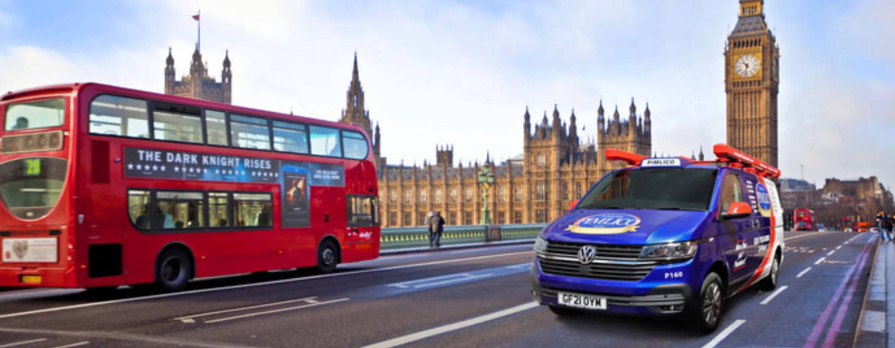 Branded Pimlico van on busy street