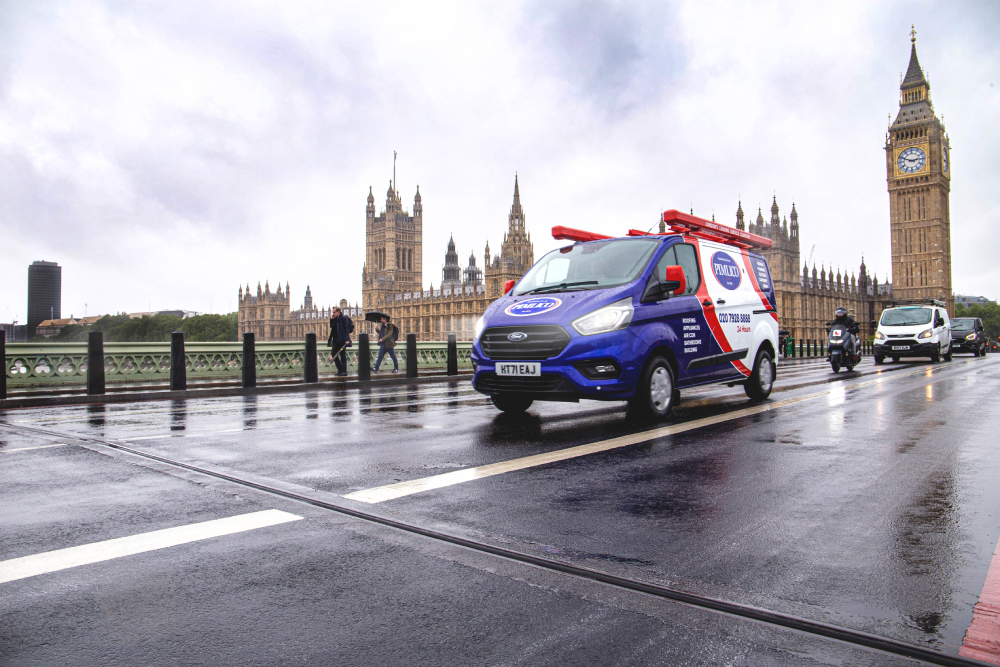 Pimlico branded truck riding down a wet rainy road.