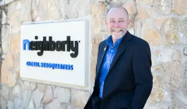 Mike Bidwell, President & CEO of Neighborly® standing in front of Neighborly® headquarters